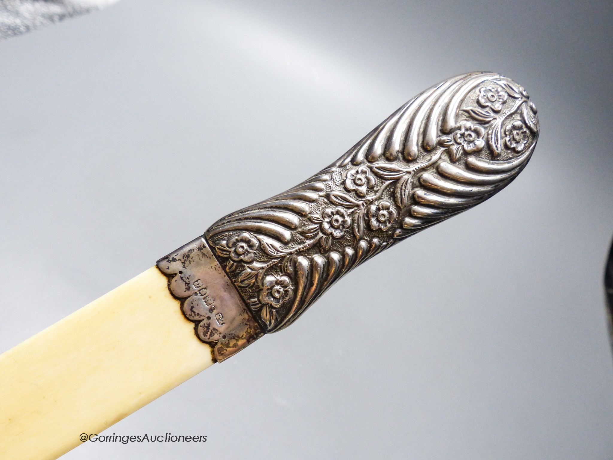A late Victorian repousse silver handled ivory page turner, Edmund Bennett, London, 1896, 41.9cm.